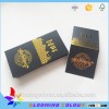 Hot sale custom black card paper hang tag/gold foil center folded swing tag