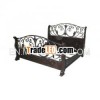 antique wrought iron and wooden bed..