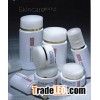 white glass cosmetic bottle and jar